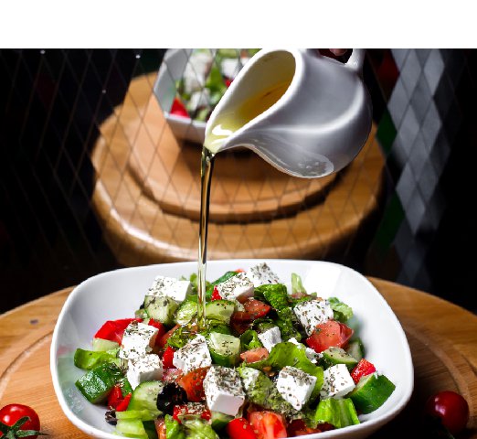 side-view-hand-pouring-olive-oil-fresh-salad-with-feta-cheese-tomatoe-cucumbers-white-bowl_Resize